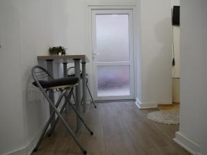 a table and a chair in a room with a door at Terazije apartment in Belgrade +6 photos