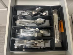 a drawer filled with silver utensils and spoons at Resort Style Apt/Home in Houston Medical Centre in Houston