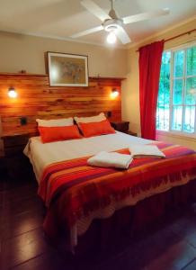a bedroom with a bed with two towels on it at Entre Árboles in San Salvador de Jujuy
