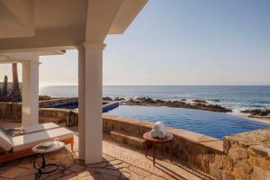 a house with a swimming pool next to the ocean at One&Only Palmilla in San José del Cabo