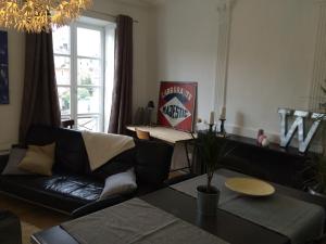 a living room with a couch and a table at Wine Home in Chambéry