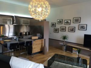 a living room with a chandelier and a kitchen at Wine Home in Chambéry