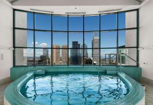 a large swimming pool in a building with a large window at Regency Towers in Melbourne
