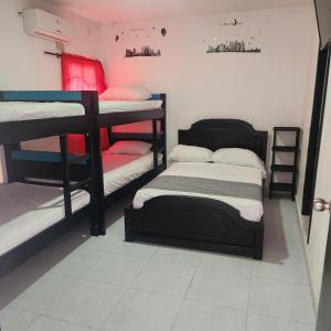 a room with three bunk beds in it at hostel Santamaria in Rodadero