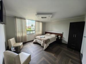 Postel nebo postele na pokoji v ubytování Hotel Douce Nuit