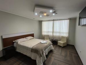Postel nebo postele na pokoji v ubytování Hotel Douce Nuit