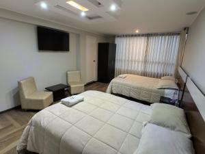 Postel nebo postele na pokoji v ubytování Hotel Douce Nuit