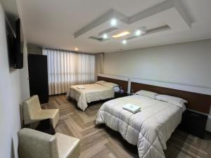 Postel nebo postele na pokoji v ubytování Hotel Douce Nuit
