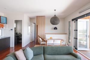 a living room with a couch and a table at Bay Properties The Chill in Yamba
