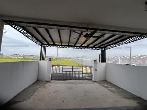 a garage with an open gate with a view of a field at Aleesa Homestay in Tapah