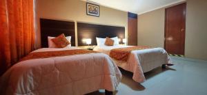 Ένα ή περισσότερα κρεβάτια σε δωμάτιο στο Hotel Los Nogales
