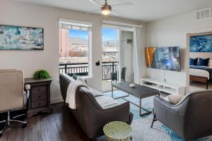 a living room with a couch and chairs and a tv at Convention Ctr Lux 2BR Pool,Htub,Gym,Theatre,Pkg in Salt Lake City