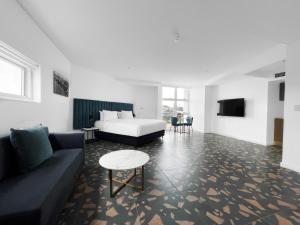 a living room with a couch and a table at Swiss-Belhotel Woolloongabba Brisbane in Brisbane