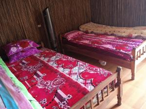 a room with two twin beds in a room at Black Hmong Sapa Homestay Family in Sa Pa