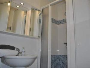 a white bathroom with a sink and a shower at Maison à Beg-Meil, calme et proche plage - FR-1-481-175 in Fouesnant