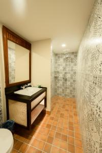 a bathroom with a sink and a mirror at Villa Deux Rivieres Hotel in Luang Prabang +53 photos