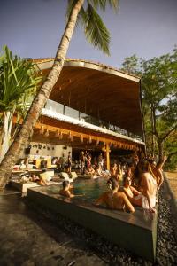 a group of people sitting in a swimming pool at Panorama Boutique Hotel & Beach Club in El Nido