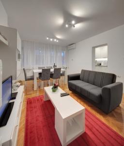 a living room with a couch and a table at Apartment Osijek-Tvrda in Osijek