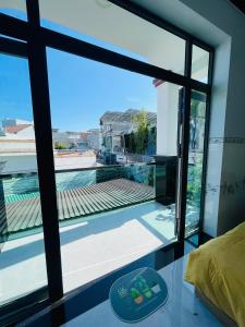 a room with a large window looking out at a pool at Cactus Homestay Ninh Thuan in Kinh Dinh +25 photos
