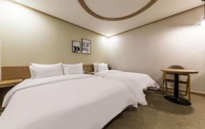 Postel nebo postele na pokoji v ubytování XYM Hotel
