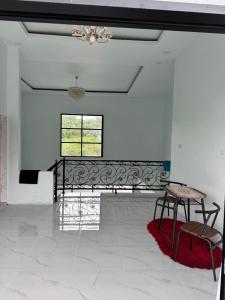 a room with a table and a bench and a window at Tropical garden regency N2 in Sibolangit