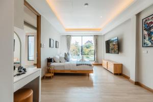 a bedroom with a bed and a large window at PureLux6 - 3BR Pool Villa in Chiang Mai