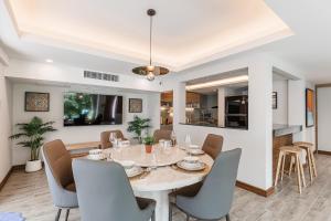 a dining room with a table and chairs at PureLux6 - 3BR Pool Villa in Chiang Mai