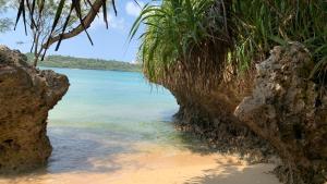 a view of the ocean from the shore of a beach at Milk-ya Women-Only Guest House in Yomitan