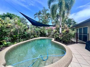 a swimming pool with a hammock in a yard at SpiritU at Mission Beach in Mission Beach