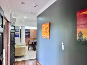 a living room with a wall with a painting on it at SpiritU at Mission Beach in Mission Beach