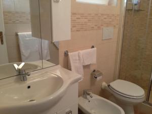 a bathroom with a sink and a toilet and a mirror at Casa Petra - Mini Open Space in Brindisi