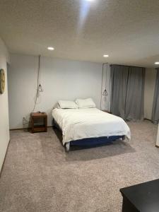a bedroom with a large bed and a table at Shore View in Anchorage