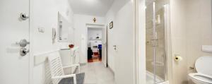 a white bathroom with a shower and a toilet at Apartment Osijek-Tvrda in Osijek +28 photos