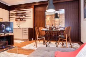 a living room with a dining room table and chairs at Centroom Apartments Zagreb in Zagreb