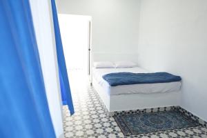 a small bedroom with a bed and a mirror at Voitto Vista in Cochin