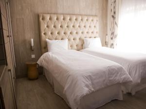 Voodi või voodid majutusasutuse La Locanda Boutique Hotel toas