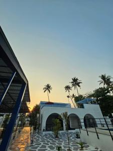 a building with palm trees in front of it at Voitto Vista in Cochin