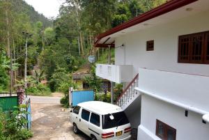 a white van parked outside of a house at Ellagama Village Bungalow in Diyatalawa