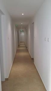 an empty hallway with white walls and a long corridor at Simos Magic Hotel Apts in Ayia Napa