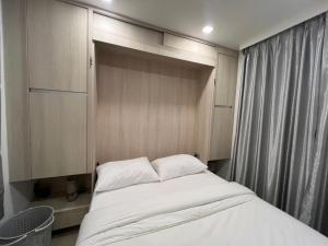 a small bedroom with a bed in a room at City Garden Olympus Condo By Vacation Vibes in Pattaya South