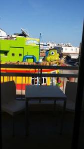 a balcony with a table and chairs on a ship at Simos Magic Hotel Apts in Ayia Napa