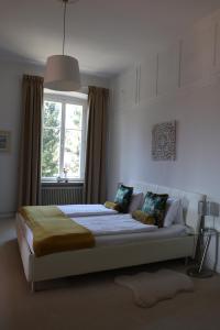 a bedroom with a large bed with a window at Villa Adrienne in Velden am Wörthersee