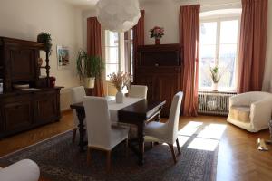 a dining room with a table and white chairs at Villa Adrienne in Velden am Wörthersee