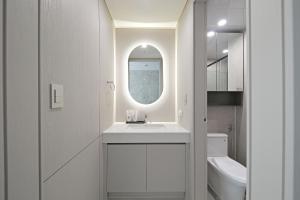 a white bathroom with a sink and a mirror at Sota Suite Busan Seomyeon in Busan +38 photos