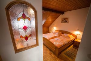 a bedroom with a bed and a stained glass window at Green Garden Apartments Soklič in Bohinj