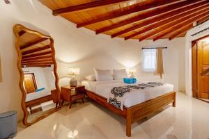 a bedroom with a large bed and a chair at Hemma Human Home in Ubud +112 photos
