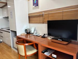 a desk with a television on top of it at Daejeon I-Hotel in Daejeon
