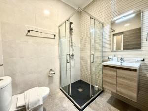 a bathroom with a shower and a toilet and a sink at New Apartment! Walking distance to the three cities by SF Homes in Fgura +14 photos