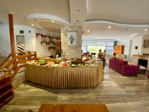 a table with plates of food on it in a room at Rain Hotel in Kizkalesi