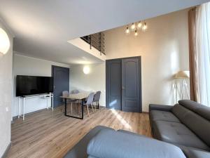 a living room with a couch and a table at 18 Deribasivska Street Jacuzzi Apartment in Odesa